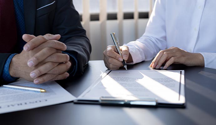 two people having a meeting with insurance documents