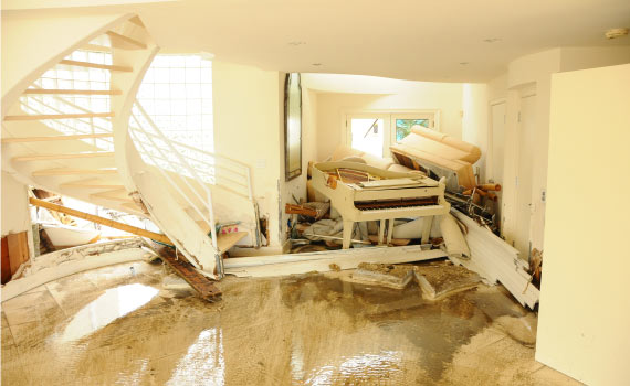 water damaged broken white piano in a living room