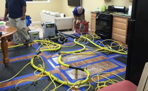 setting up equipments to repair water damaged room and furniture