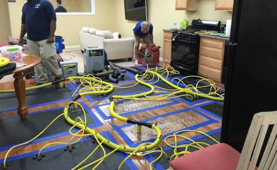 setting up equipments to repair water damaged room and furniture